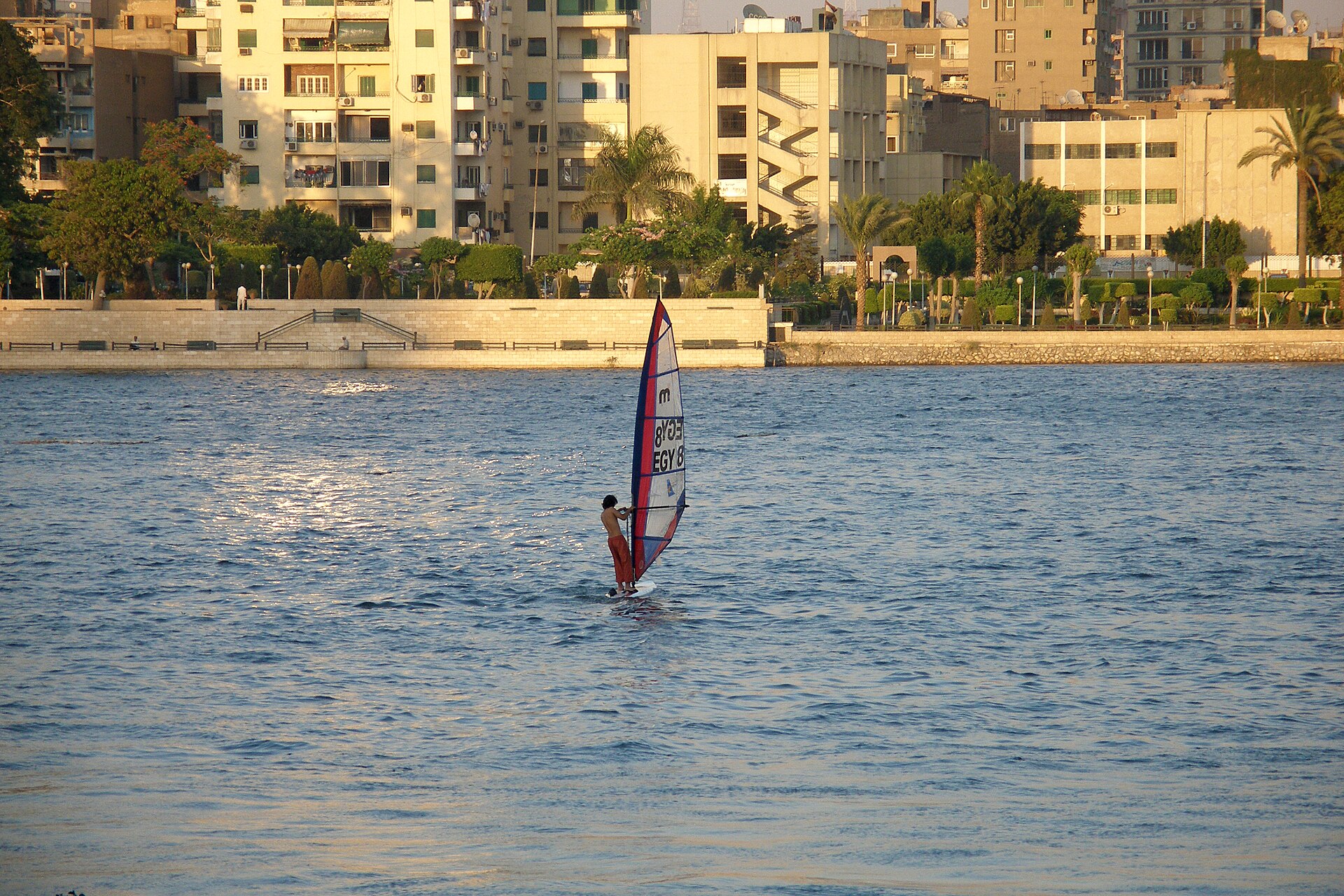 A windsurfer on the Nile in Cairo in front of apartment buildings