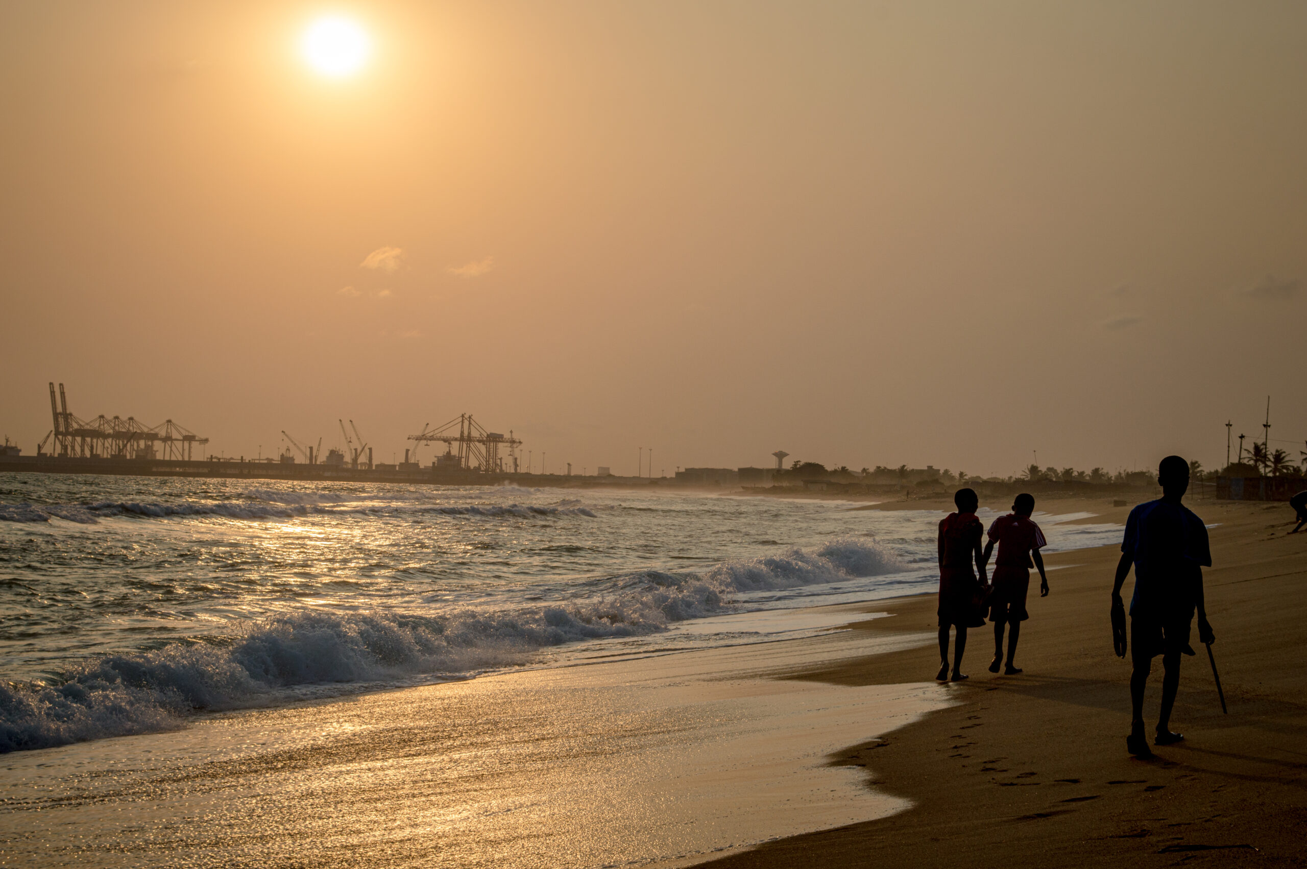 The shoreline at Lome, Togo, with the port cranes beyond
