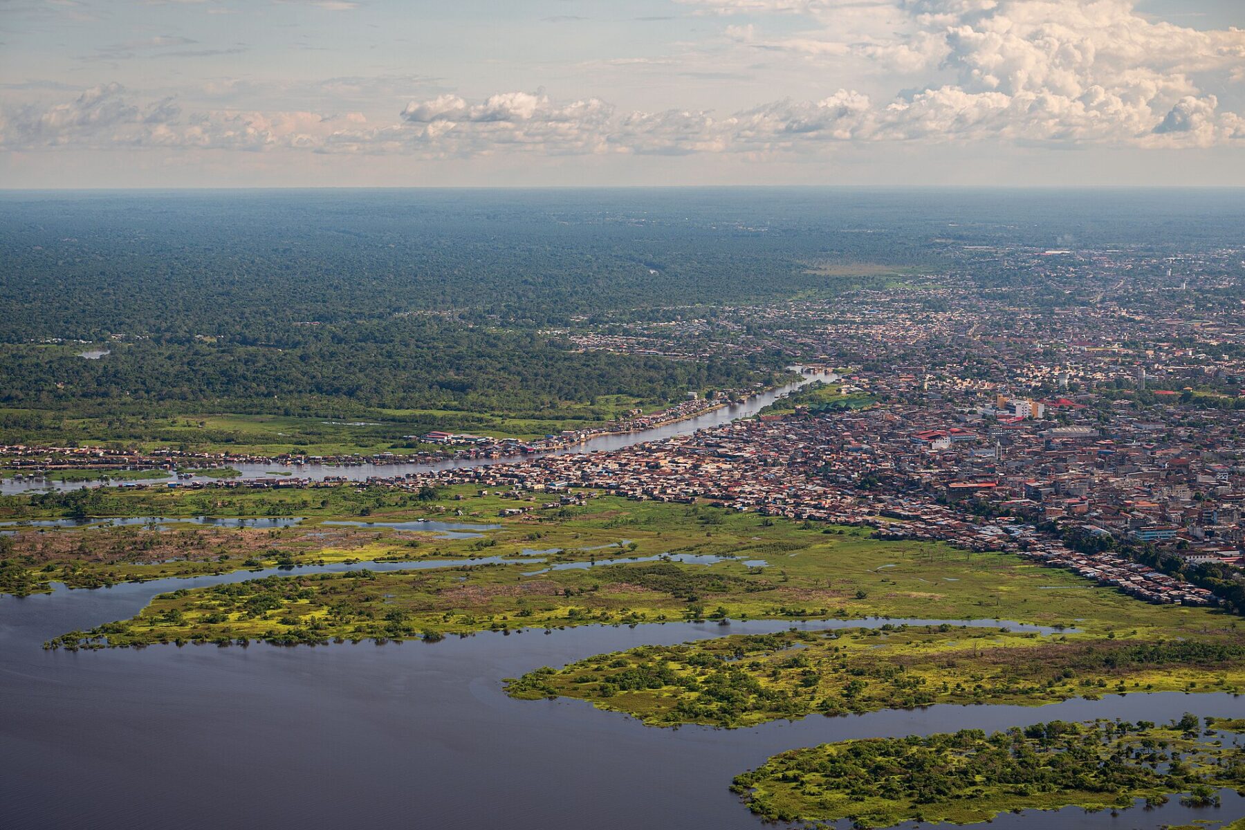 Aerial view of a city along a river in a tropical region