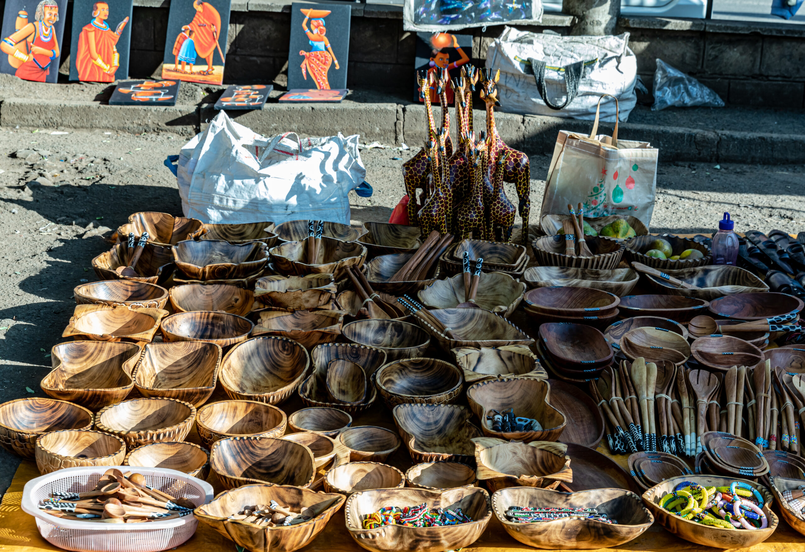 Kenya foreign traders — carved bowls and curios laid out on a trader's stall in Nairobi