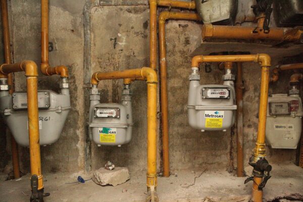 Argentina gas subsidy: household gas meters on yellow pipes in a building in Buenos Aires