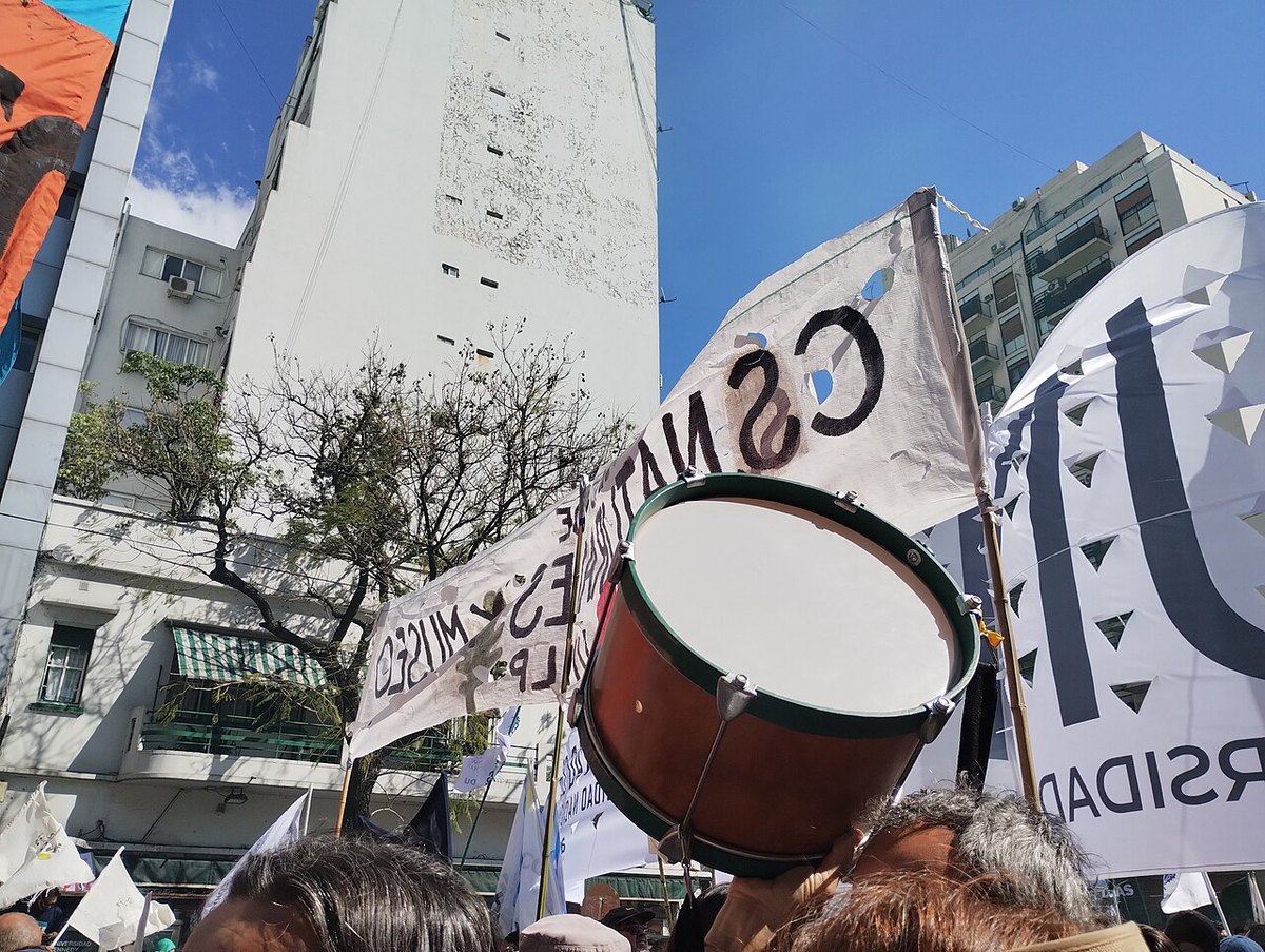 Protesters with a drum and university banners in Buenos Aires