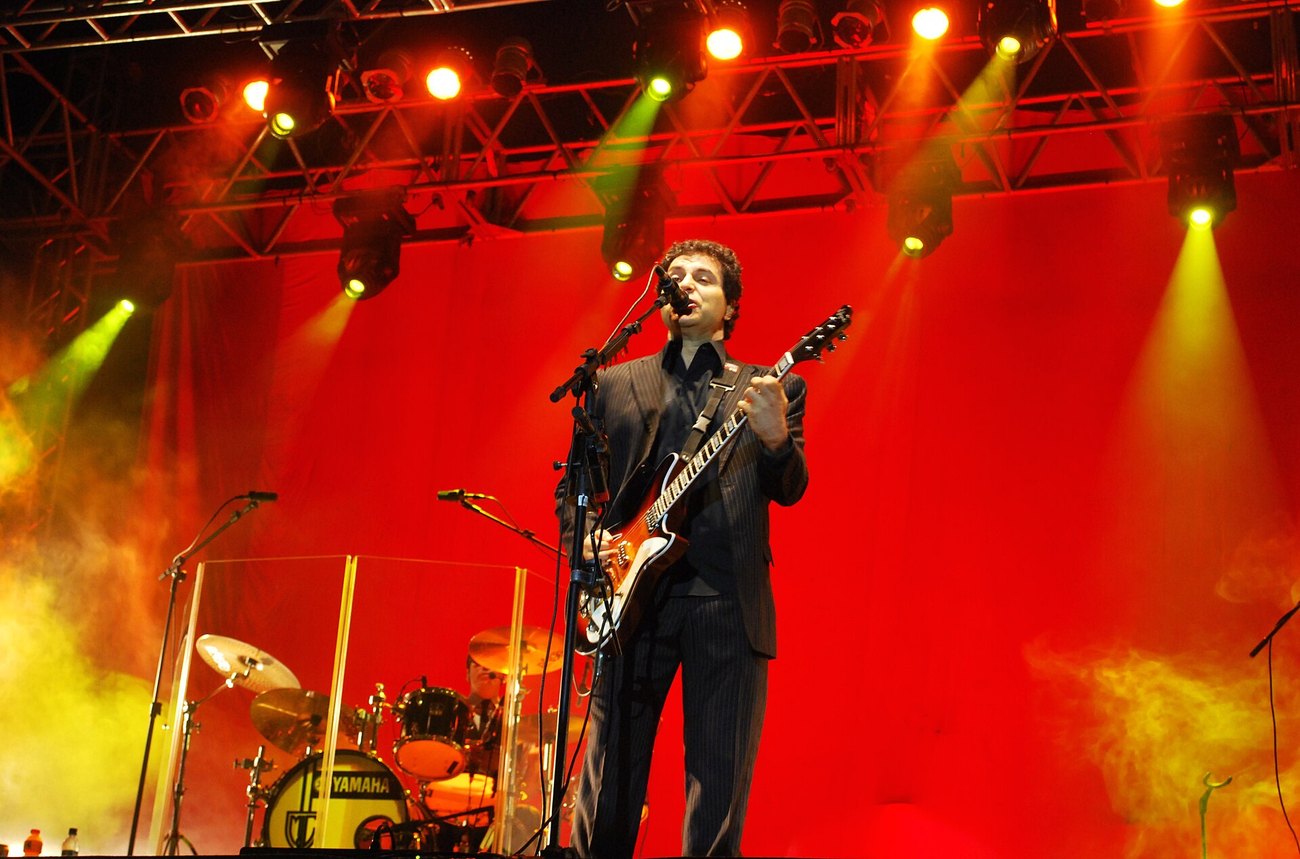 Roberto Frejat of Barão Vermelho playing guitar and singing on stage