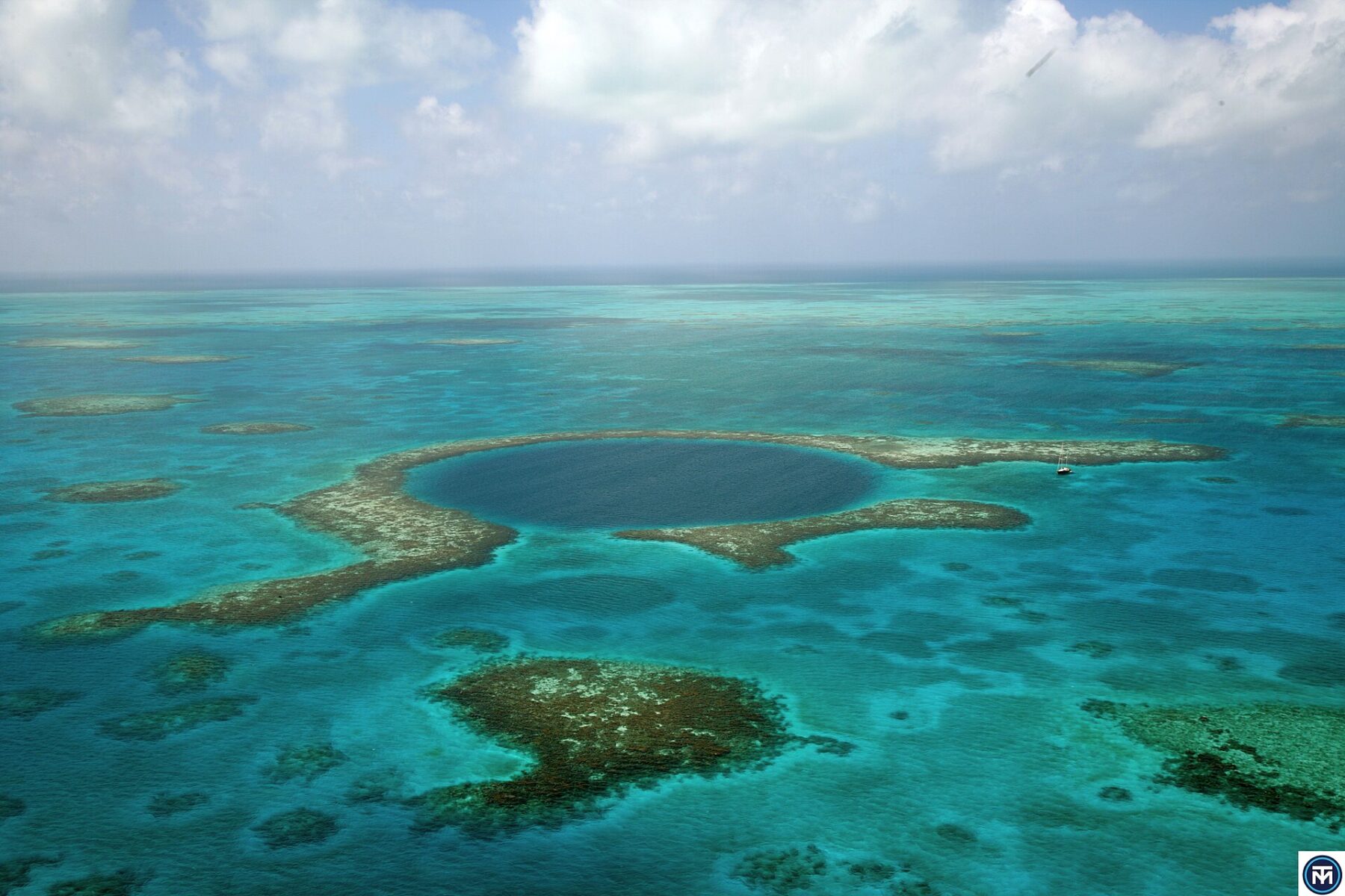 Belize explained 2026 — aerial view of the Great Blue Hole on the Belize Barrier Reef