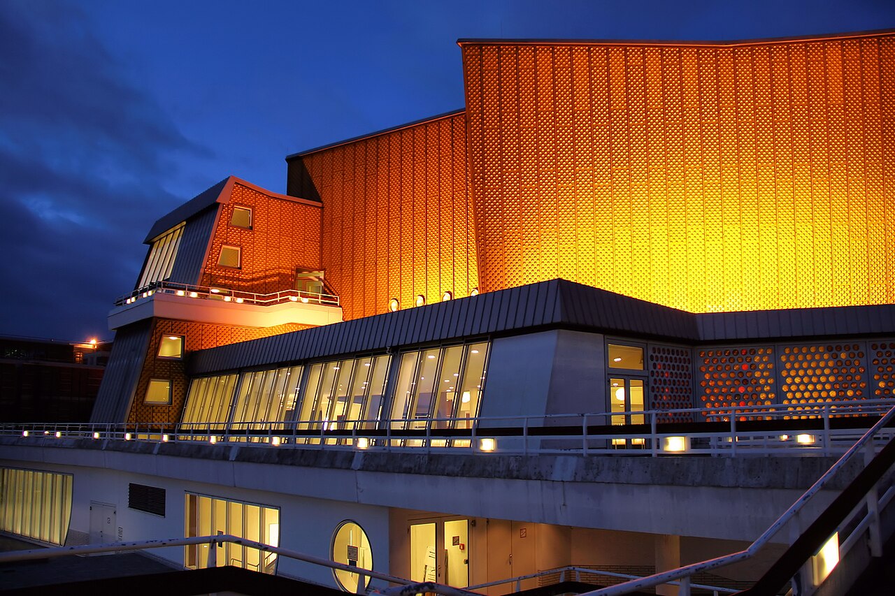 The golden Philharmonie concert hall in Berlin at dusk, home of the orchestra behind the Berlin Philharmonic Bogotá concerts