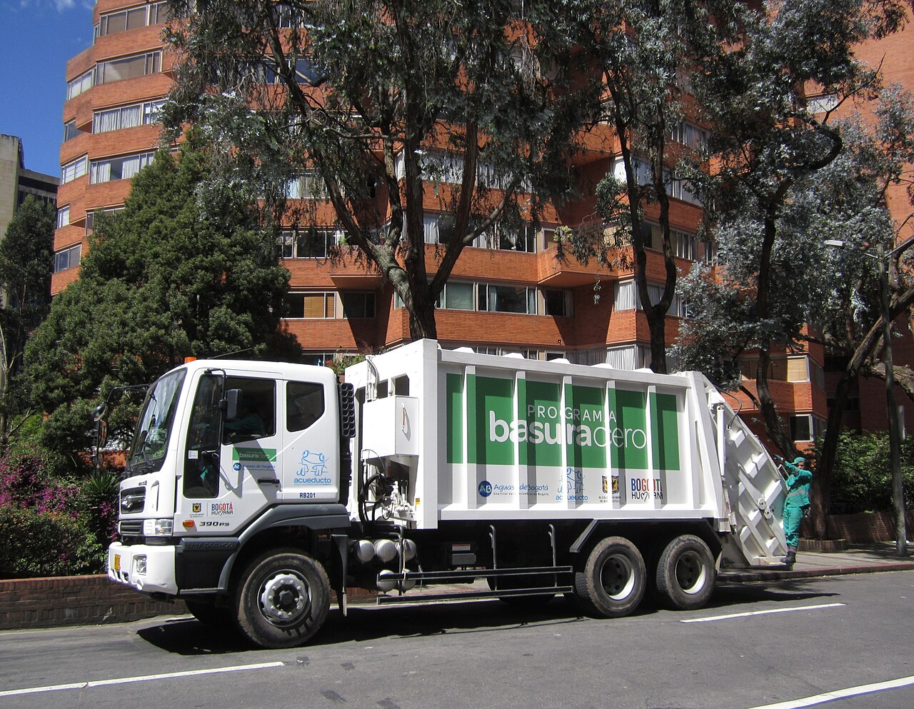 An informal recycler sorts recyclable materials on a Bogotá street