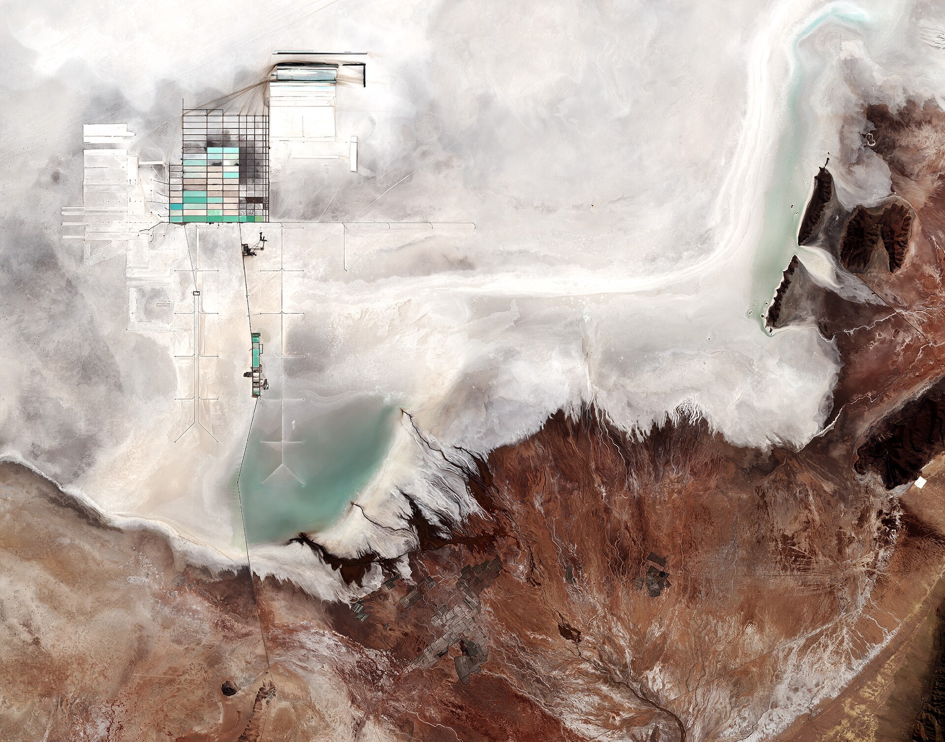 Bolivia explained 2026 — satellite view of the Salar de Uyuni with the grid of lithium evaporation ponds