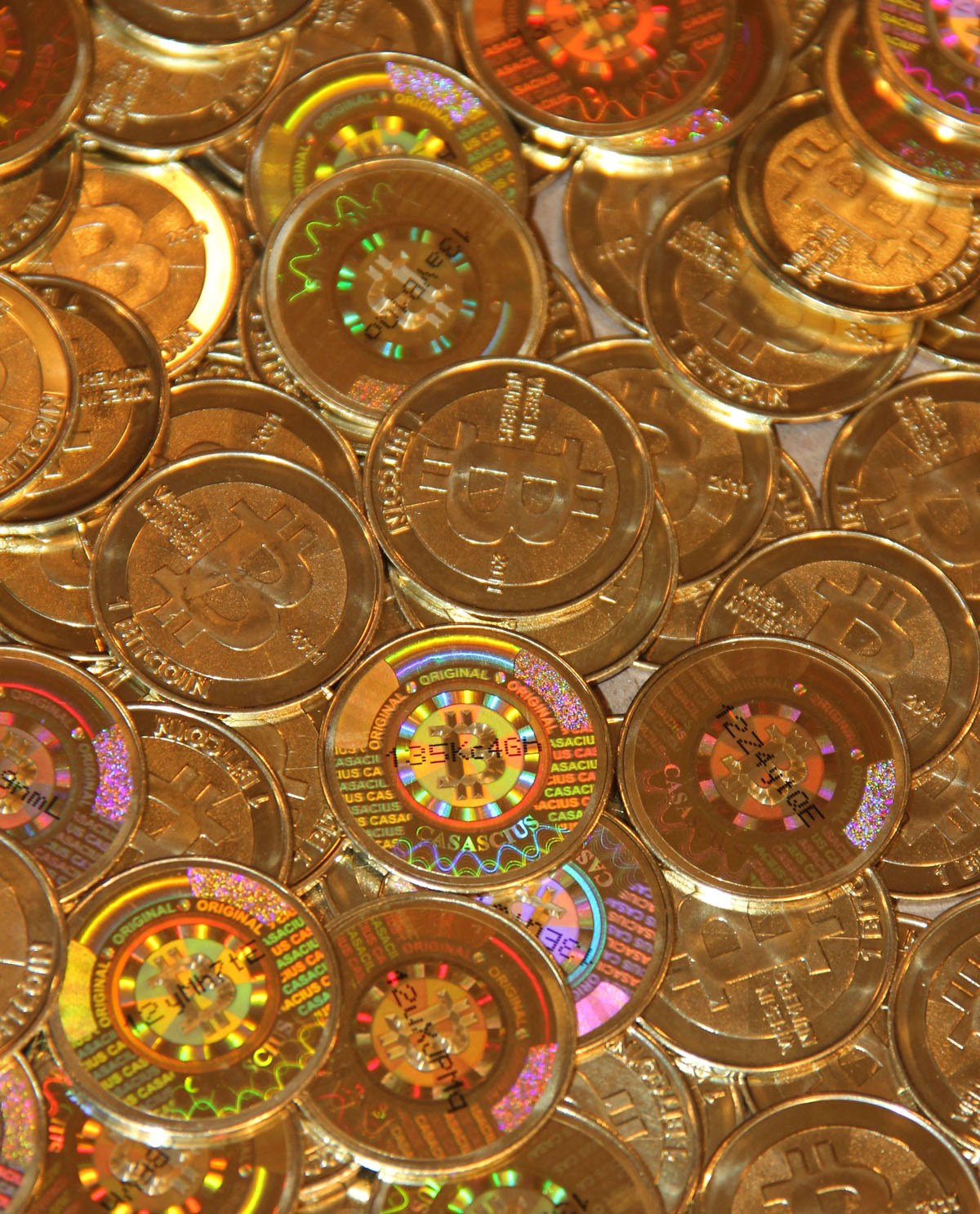 A pile of Casascius physical Bitcoin tokens.