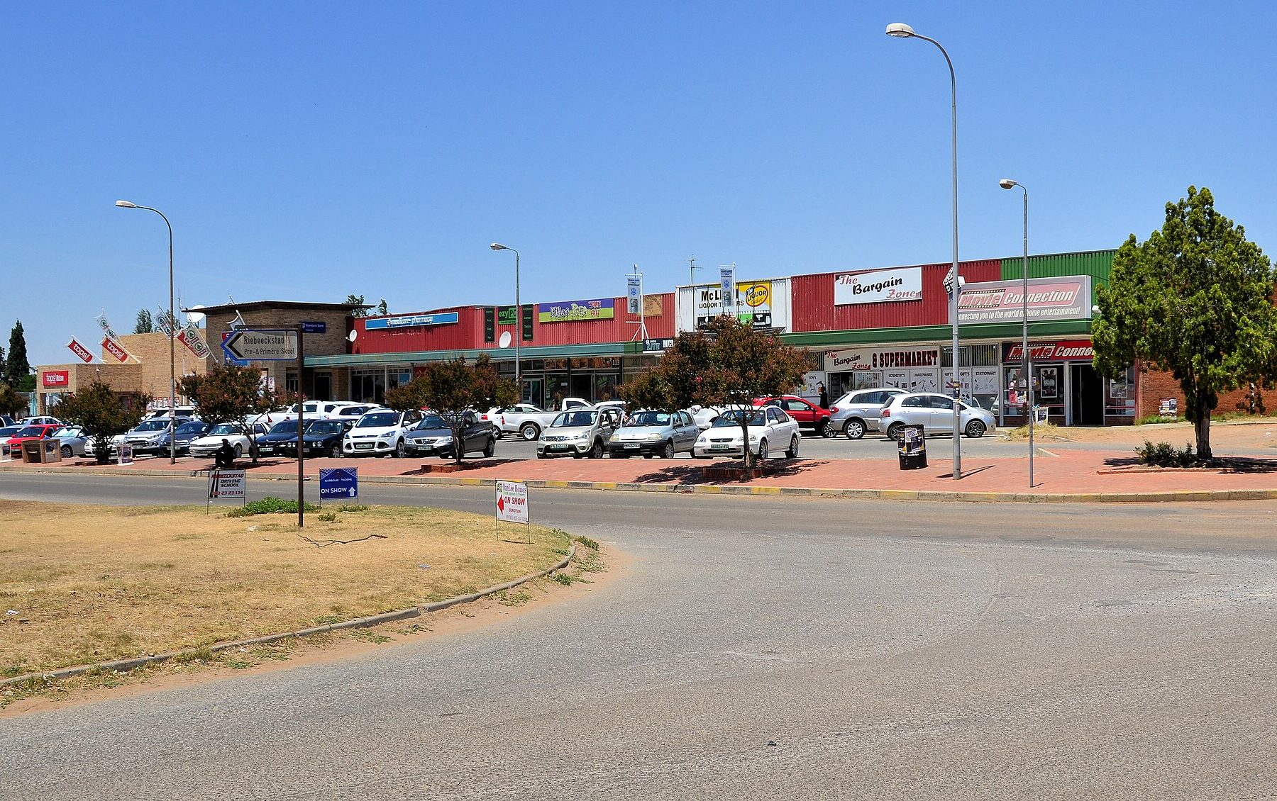 Shopping centre with parked cars in Riebeeckstad, Free State, South Africa
