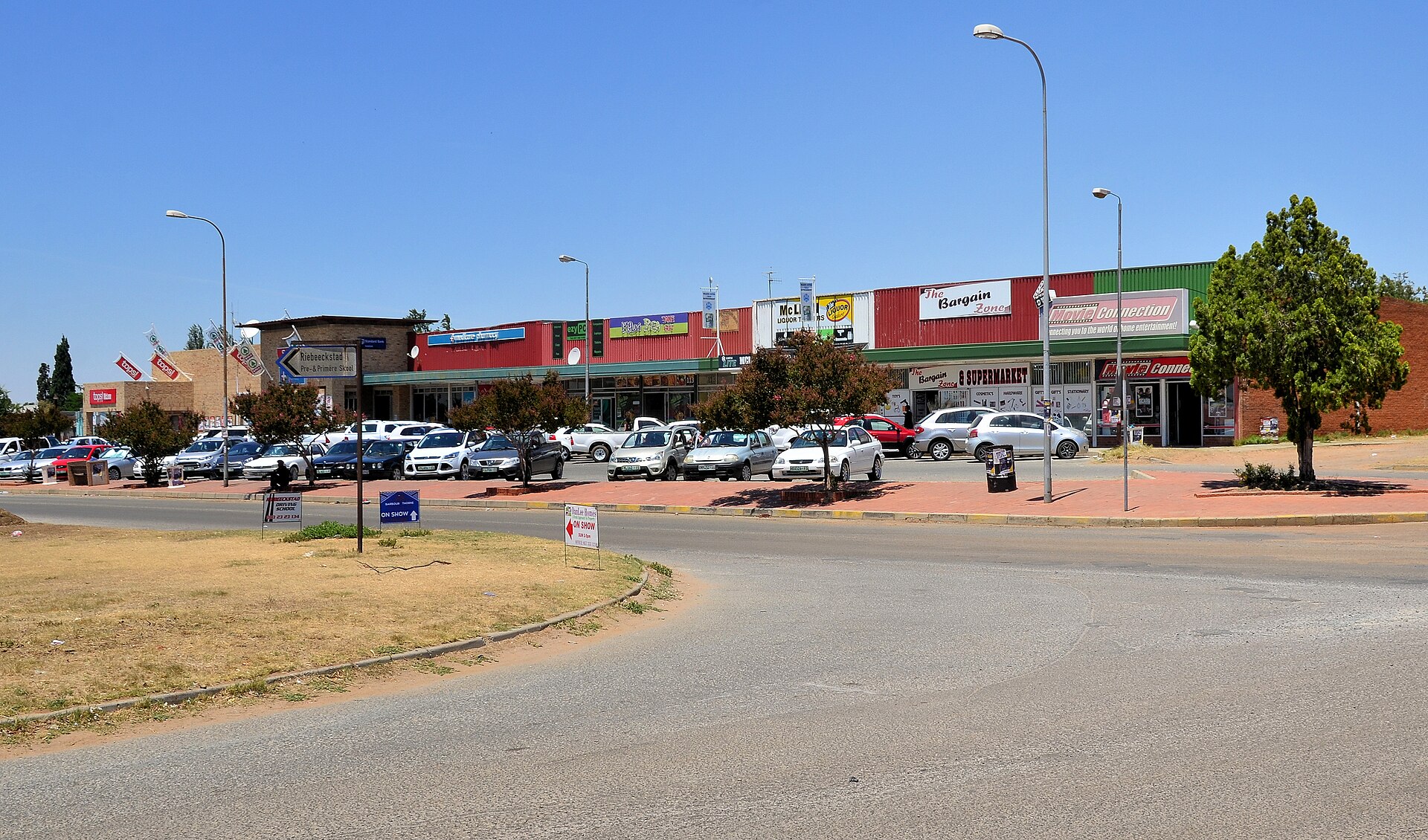 Shopping centre with parked cars in Riebeeckstad, Free State, South Africa