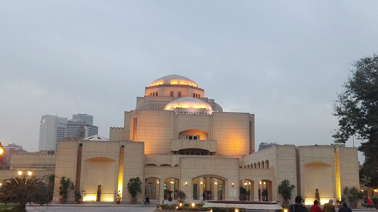 The domed main building of the Cairo Opera House lit up at dusk on Gezira Island, Cairo
