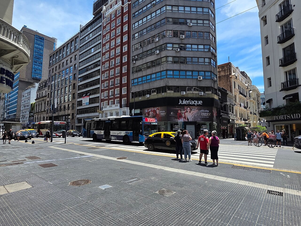 Argentina economic activity: pedestrians, a taxi and a city bus at a crossing on Calle Florida in central Buenos Aires