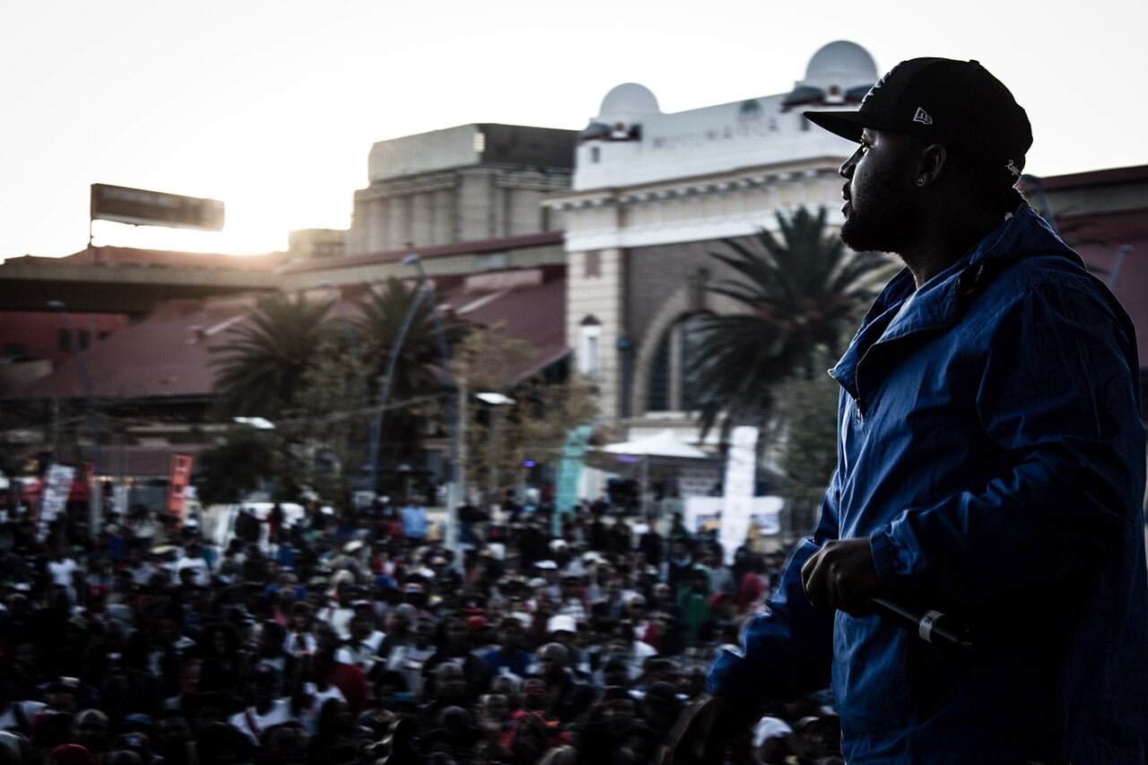Cassper Nyovest on stage facing a large crowd in Newtown, Johannesburg, at the Back to the City Festival