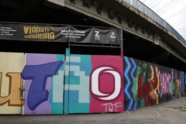Charme dance in Rio: the Madureira overpass with a banner for the Saturday Baile Charme and a painted mural reading Charme