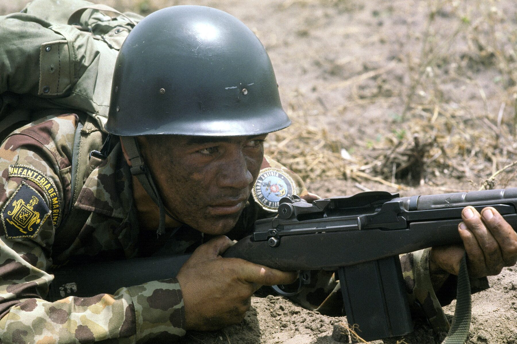 Soldiers of a Latin American army on patrol in rural terrain