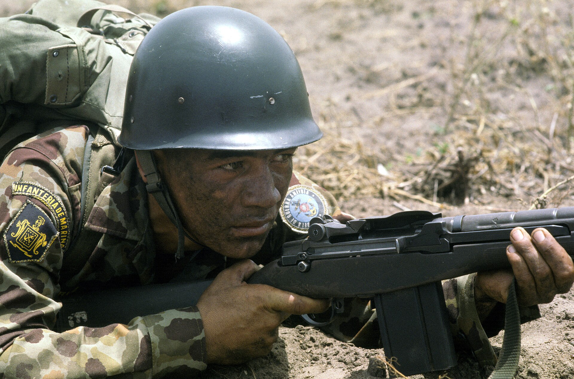 Soldiers of a Latin American army on patrol in rural terrain