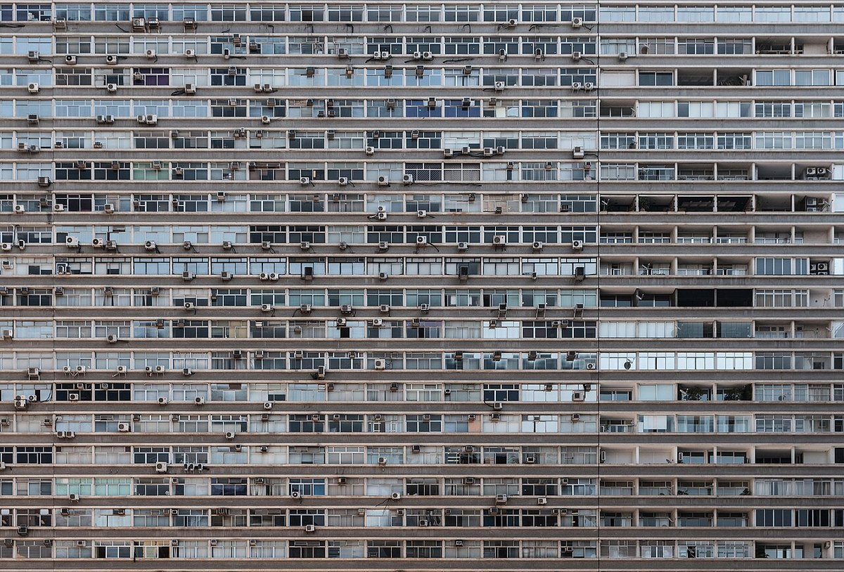 Close view of the long horizontal window bands and air-conditioning units on the modernist facade of the Conjunto Nacional