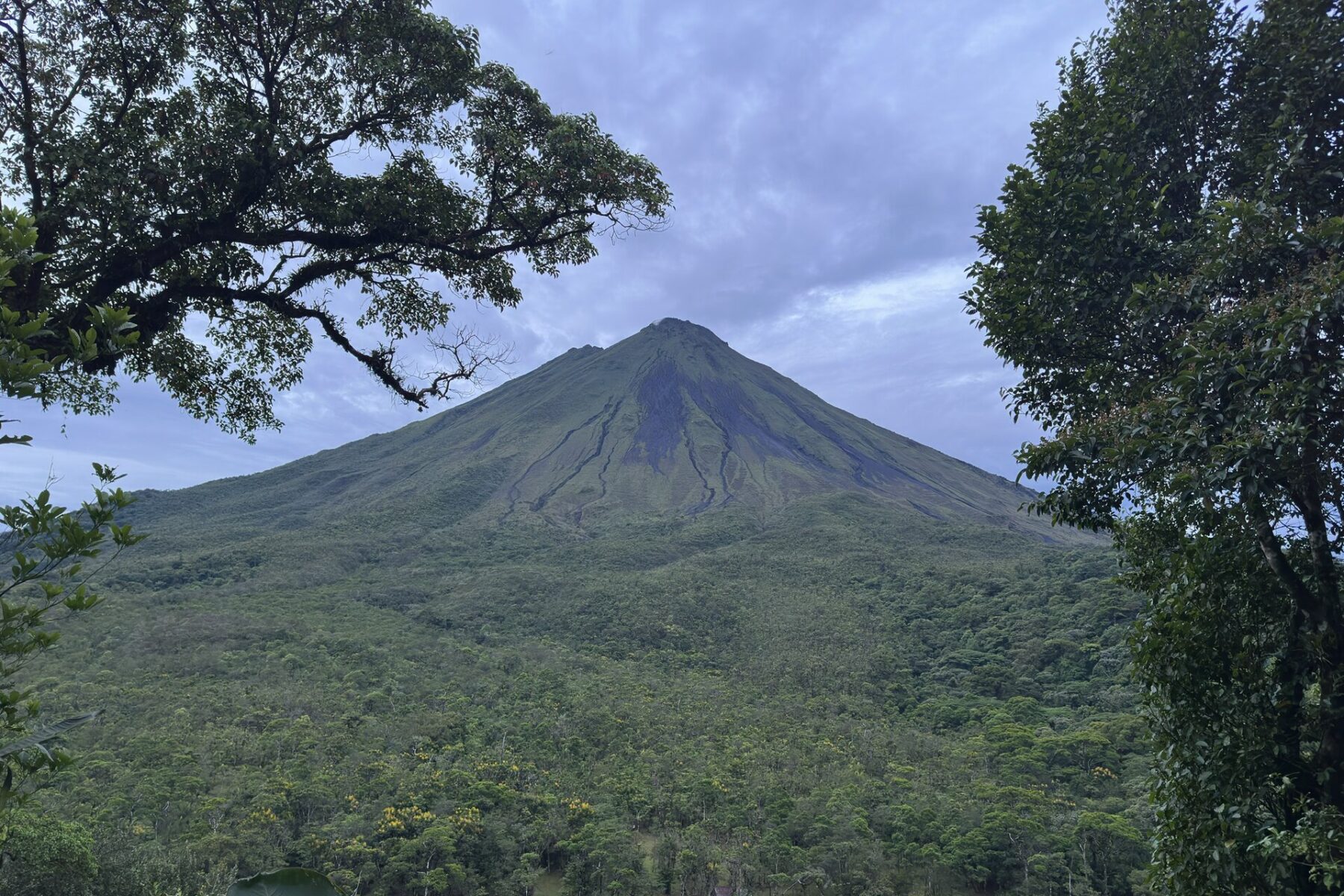 Costa Rica explained 2026 — Arenal Volcano rising above rainforest in Arenal Volcano National Park