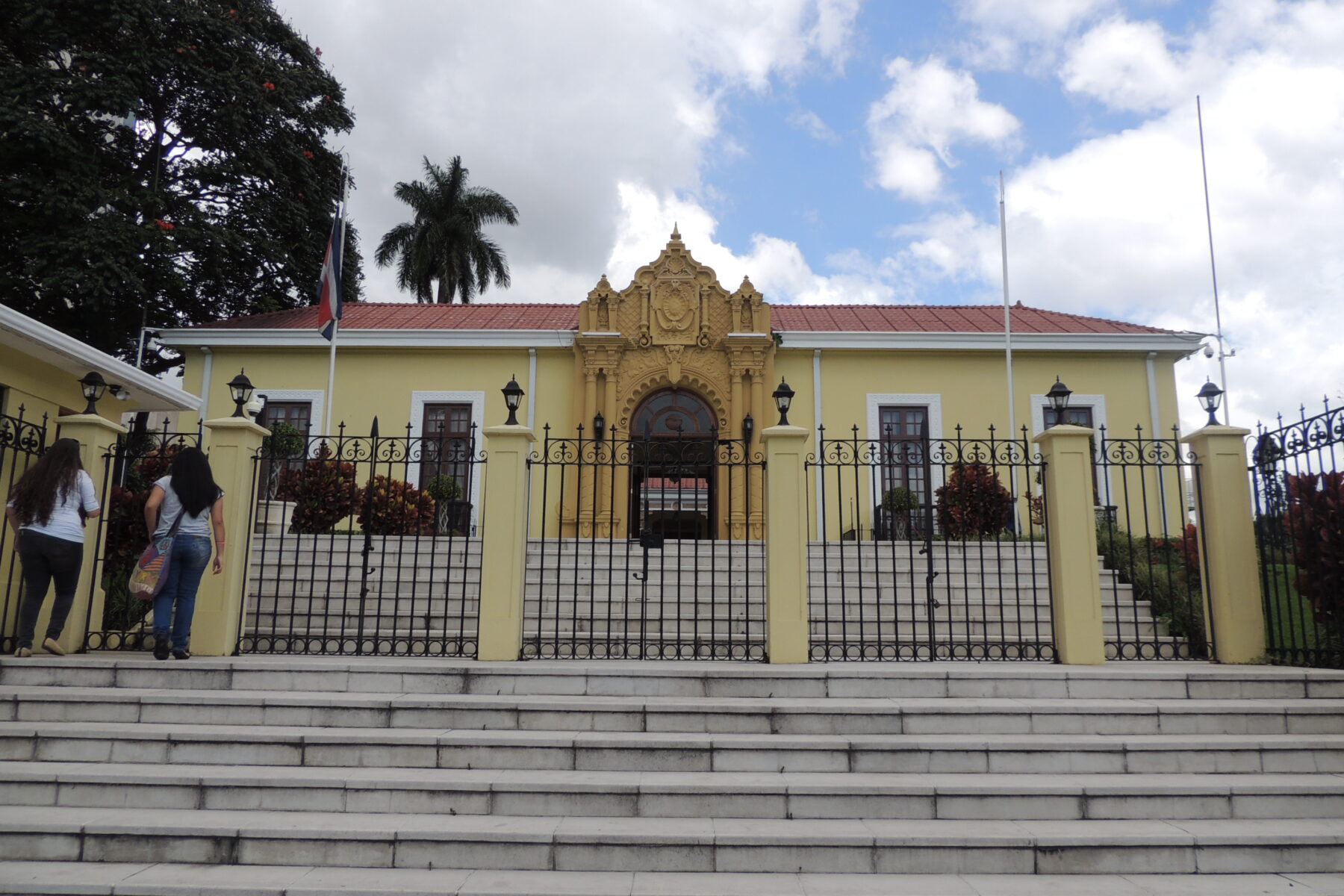 The Foreign Ministry of Costa Rica in San José, a yellow historic building behind an iron fence, with the Costa Rican flag