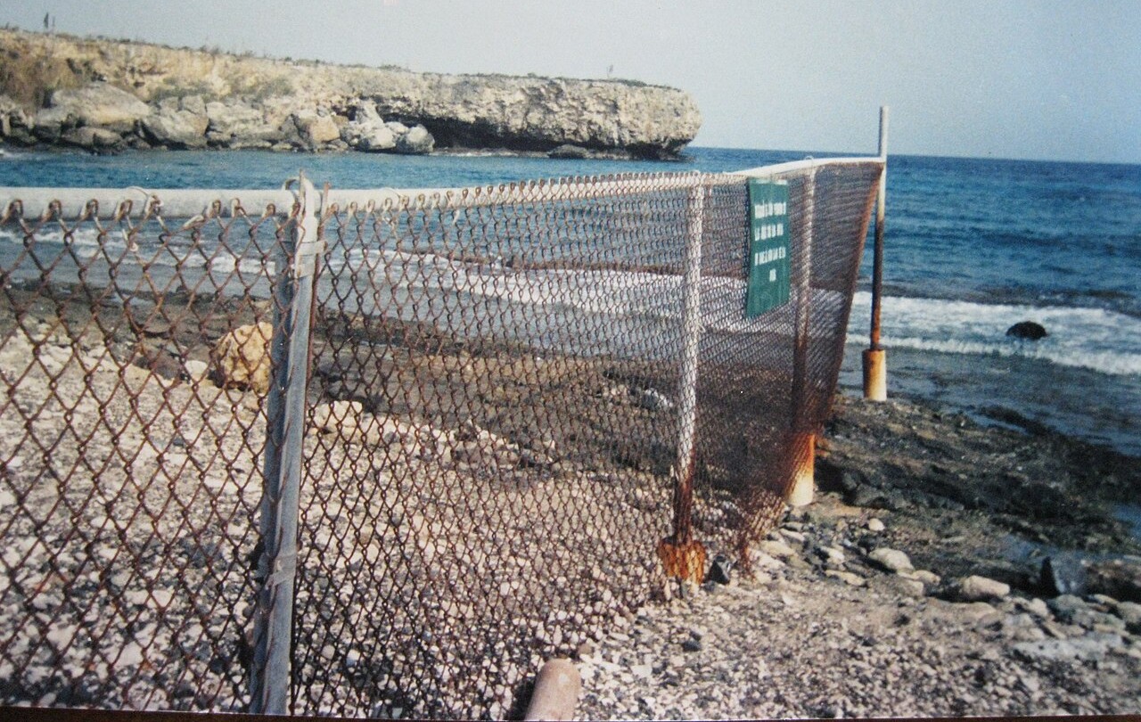 Cuba military planning: the fence on the US–Cuban border at the Guantánamo Bay naval base, beside the sea