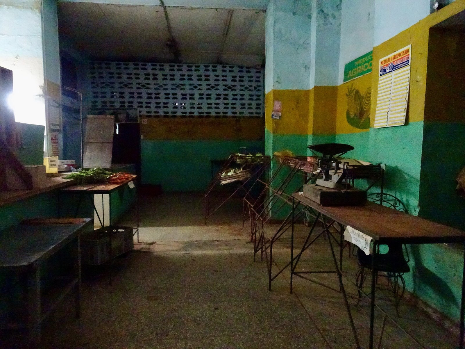 Cuba market reforms: a sparsely stocked farmers’ market in Havana with empty stalls, a scale and a few vegetables