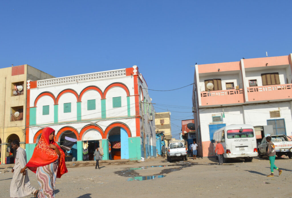 Street scene with colorful buildings and people in an African city