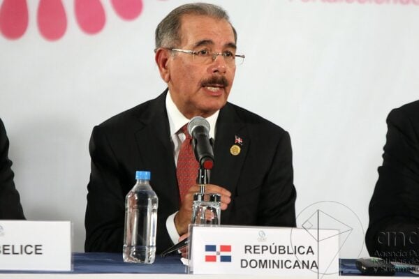 Dominican opposition party: Danilo Medina, PLD president and former Dominican president, speaks at a press conference behind a República Dominicana name card
