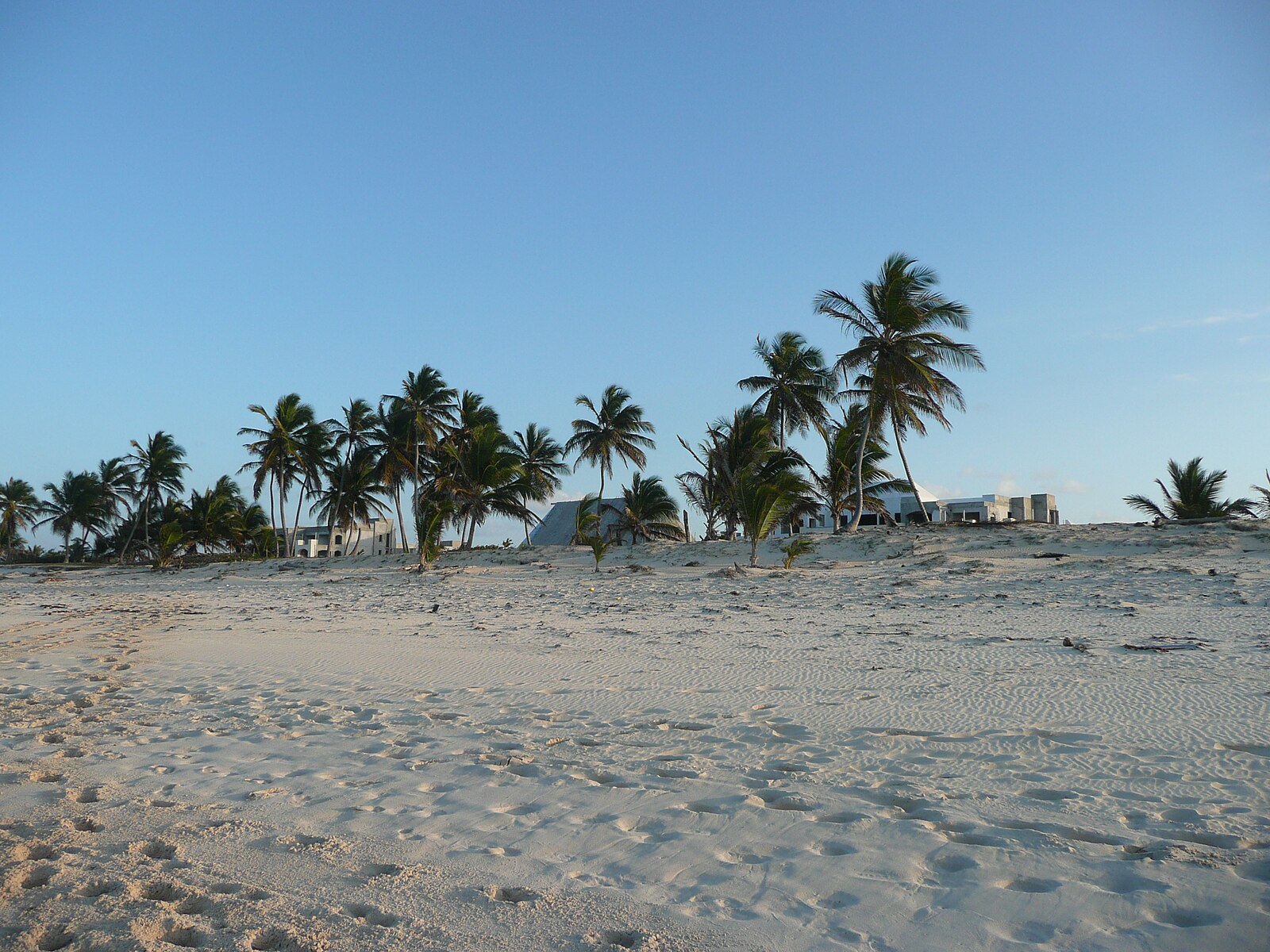 Dominican Republic tourism — villas under construction behind a beach in Punta Cana