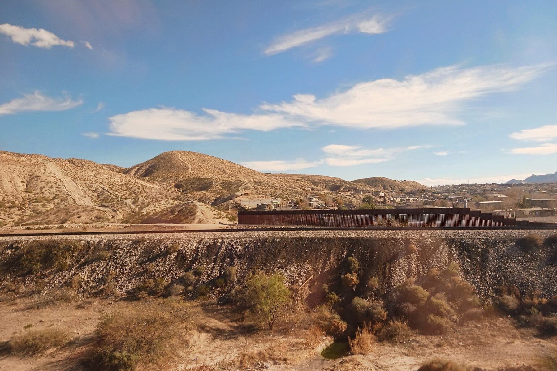 A section of border fence running through desert hills near Anapra, New Mexico