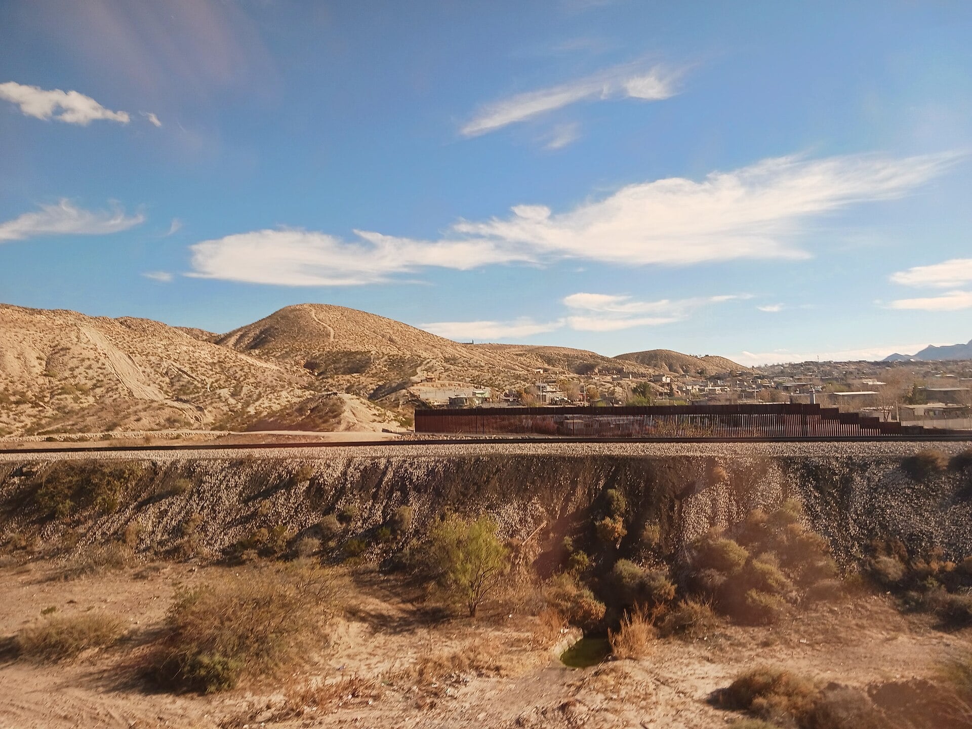 A section of border fence running through desert hills near Anapra, New Mexico