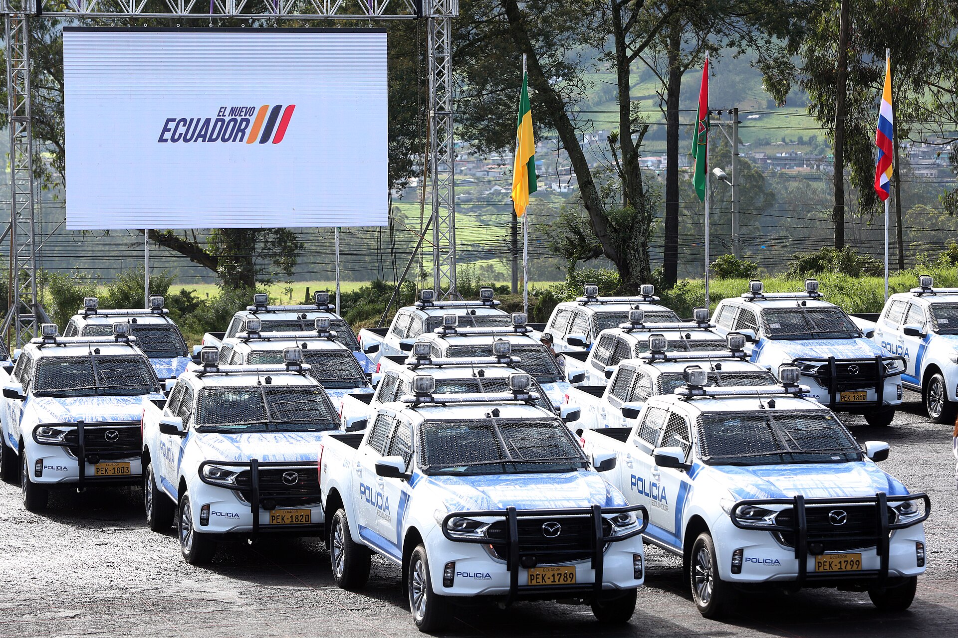 Rows of white Ecuadorian National Police pickup trucks marked Policía