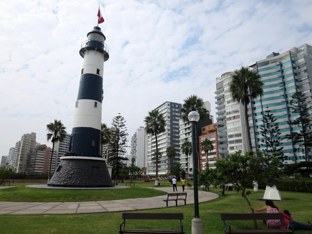 Lighthouse in Lima, Peru with buildings and park