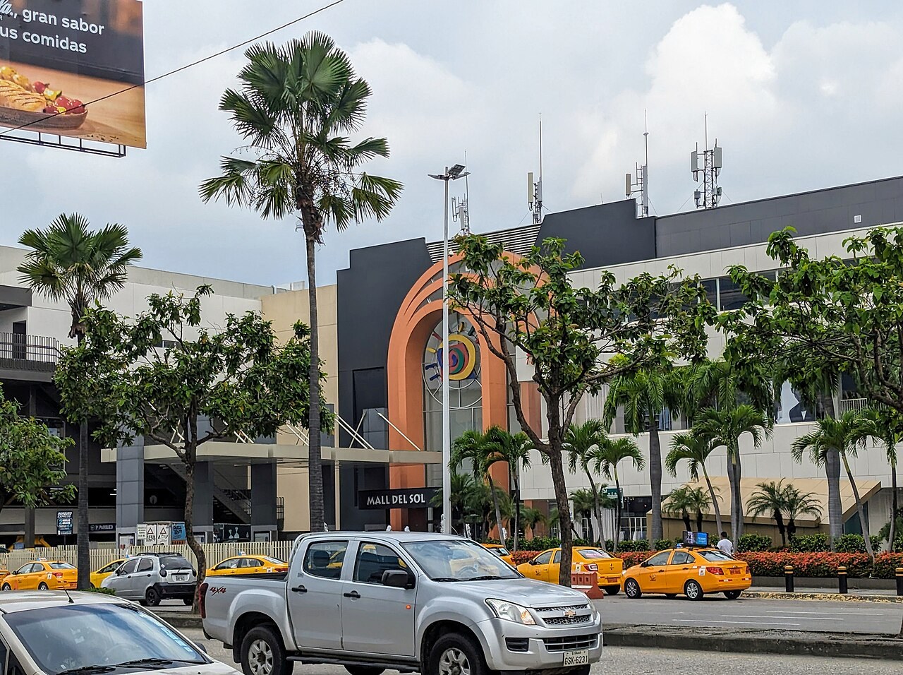 Ecuador Black Friday - Facade of the Mall del Sol shopping centre in Guayaquil with palm trees and taxis
