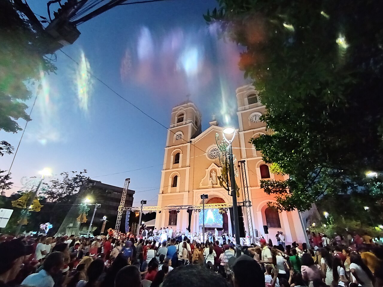 Colombia prison transfer - Sincelejo cathedral lit up at night with a crowd in the square in front