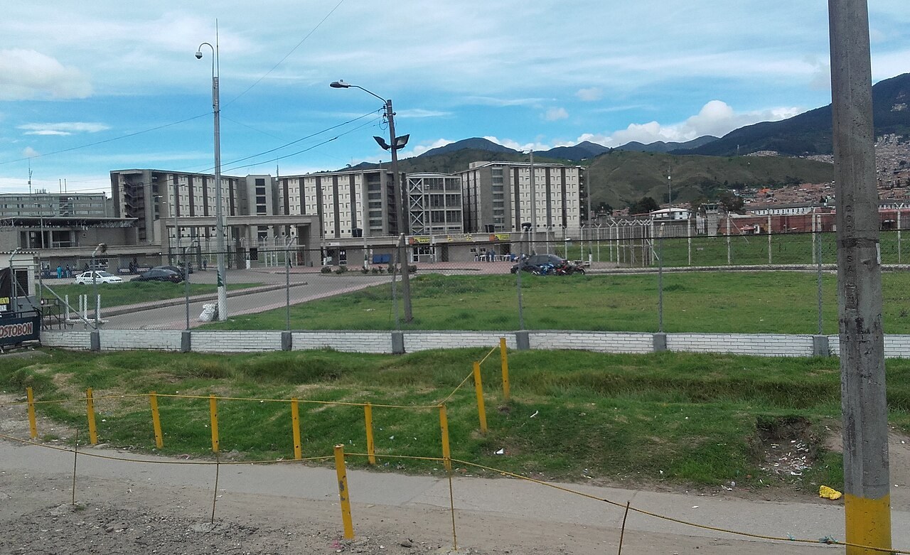 Wadith Manzur - La Picota prison buildings in southern Bogotá seen across a grassy field
