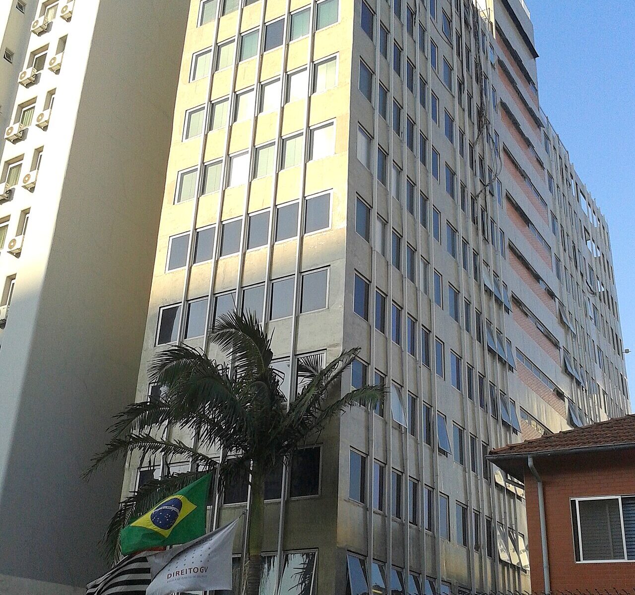The Getulio Vargas Foundation law school building in São Paulo's Bela Vista district, with Brazilian and São Paulo state flags at the entrance