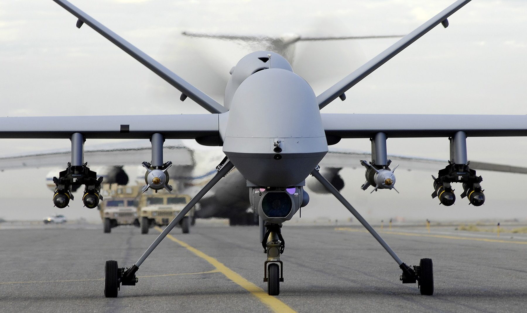 An armed MQ-9 Reaper drone on an airfield, seen head-on