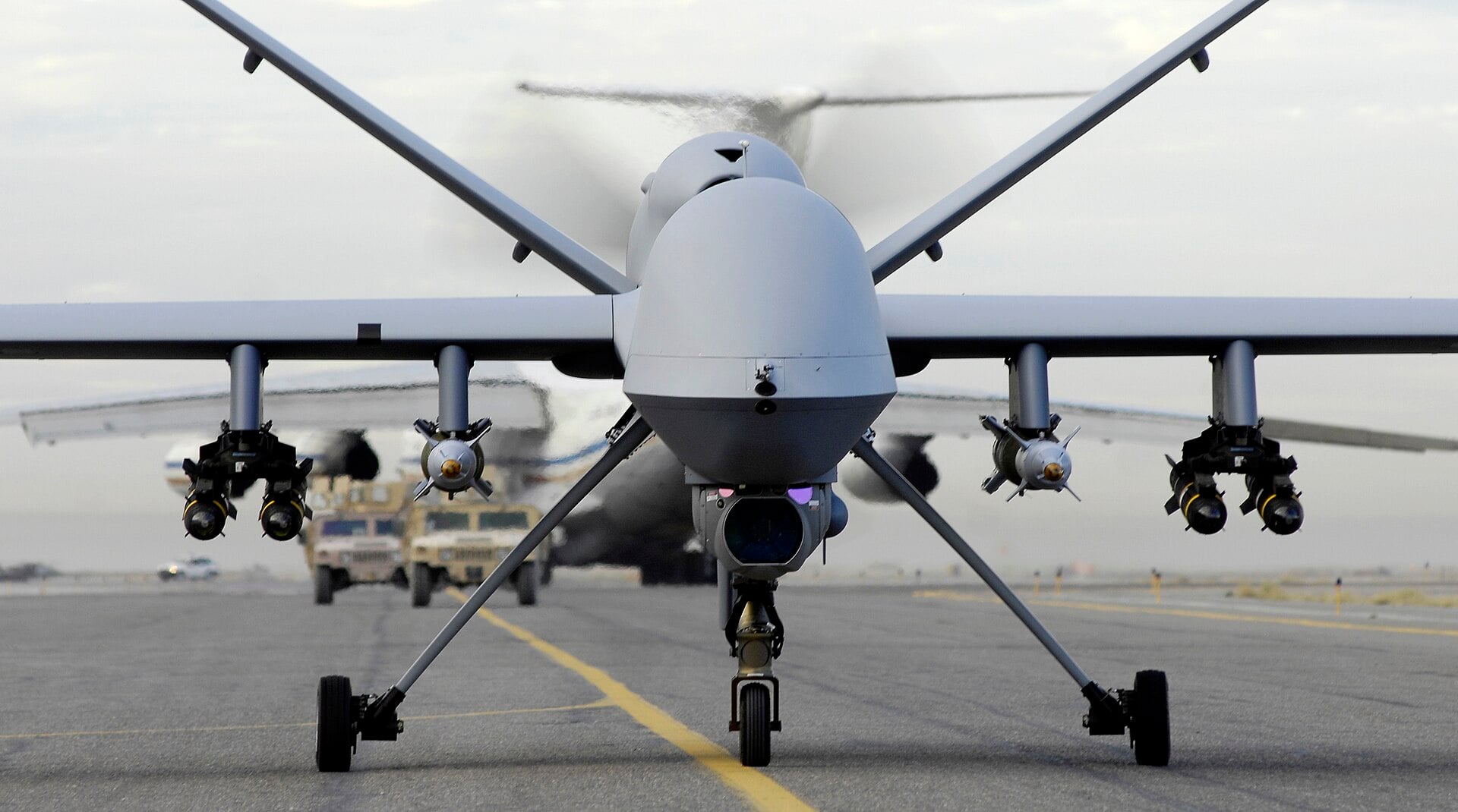 An armed MQ-9 Reaper drone on an airfield, seen head-on