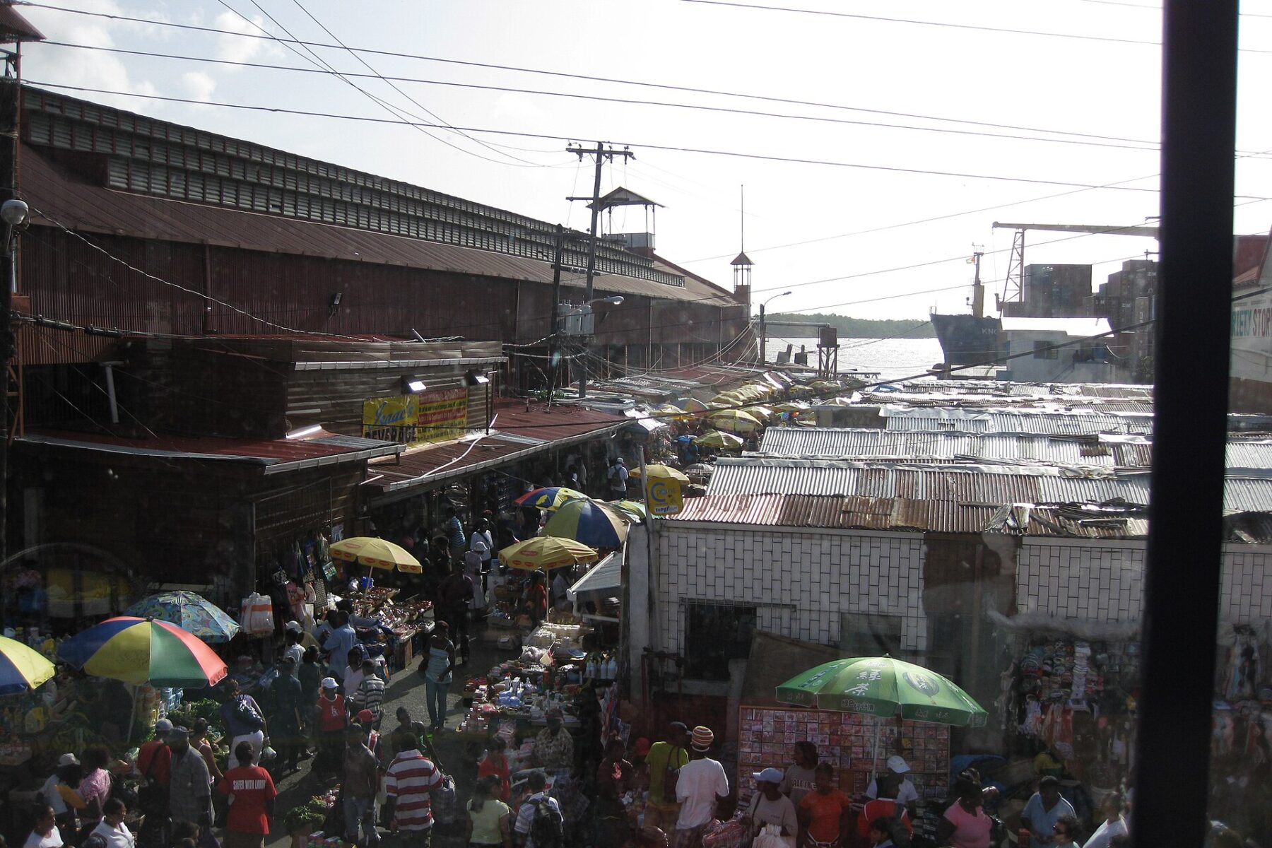 Guyana explained 2026 — street stalls beside Stabroek Market with the Demerara River port behind