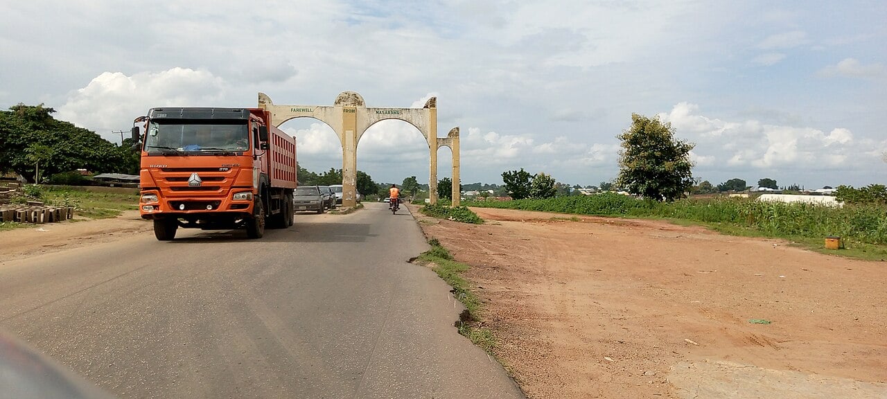 A truck passes the welcome arch on a road into Nasarawa State, where the Nasarawa mining ban applies