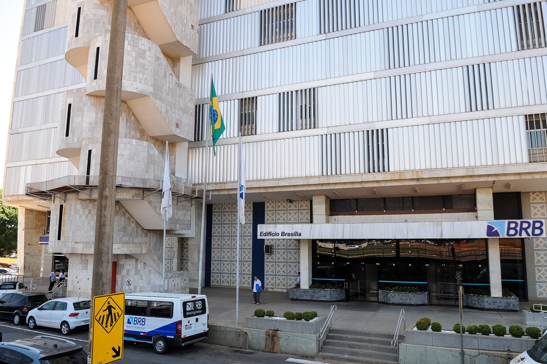 The marble facade of the BRB building in Brasilia with the Brazilian flag flying outside