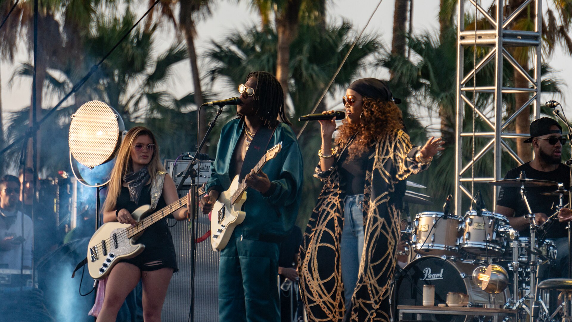 Musicians performing on an outdoor festival stage