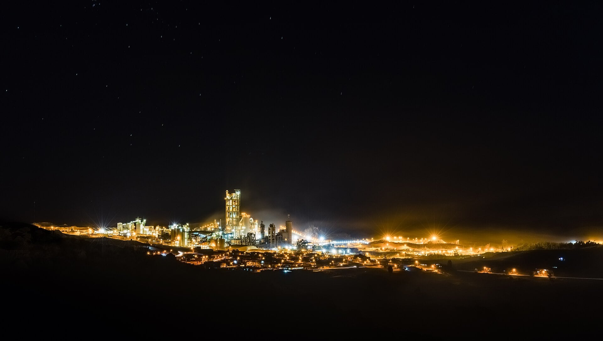 A cement plant lit up at night in Yura, Peru