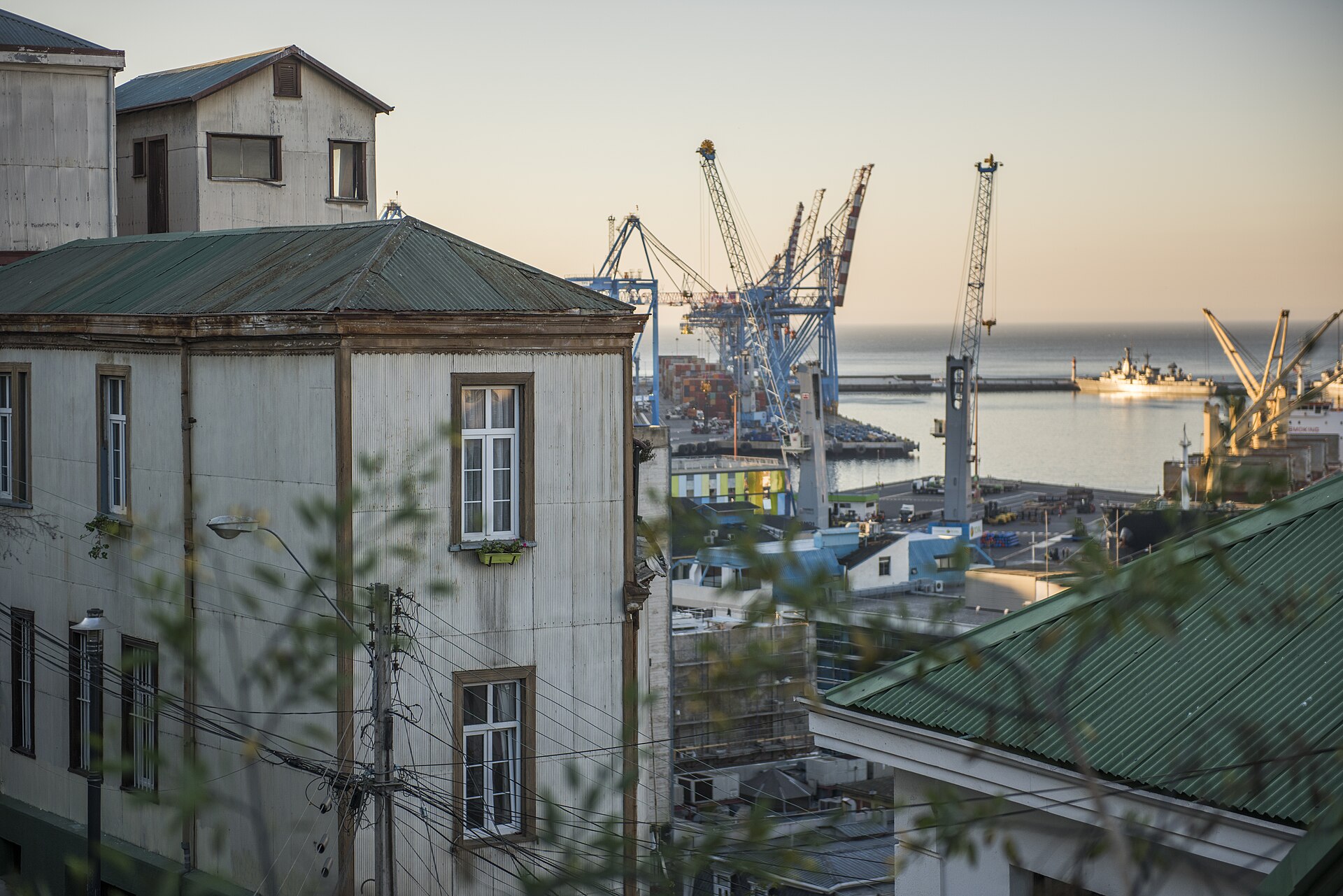 Port cranes seen over rooftops at Valparaiso, Chile