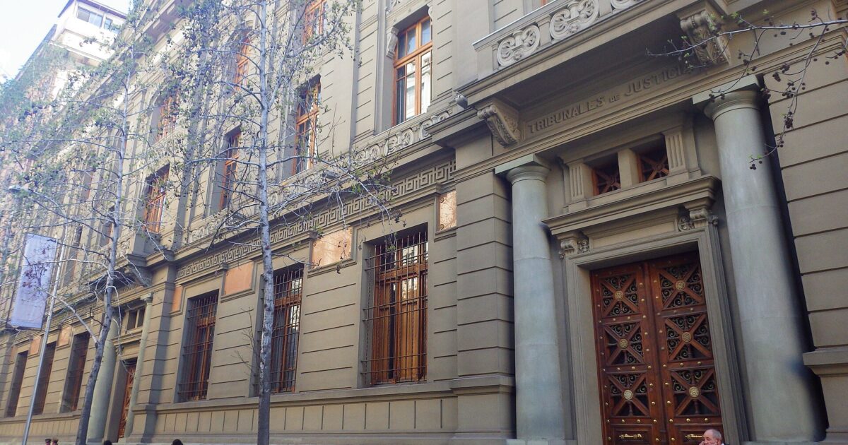 The neoclassical stone facade of the Palace of the Courts of Justice seen from Bandera street in Santiago