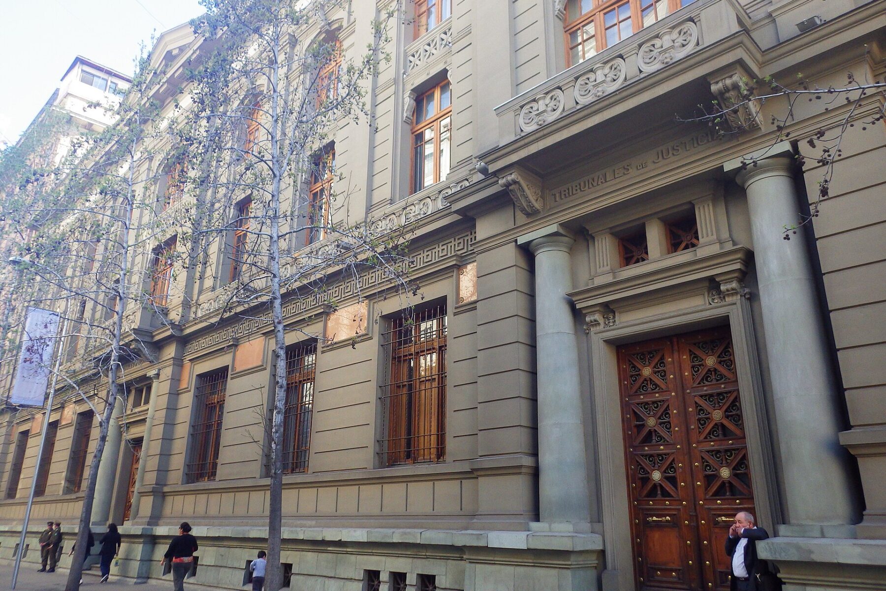 The neoclassical stone facade of the Palace of the Courts of Justice seen from Bandera street in Santiago