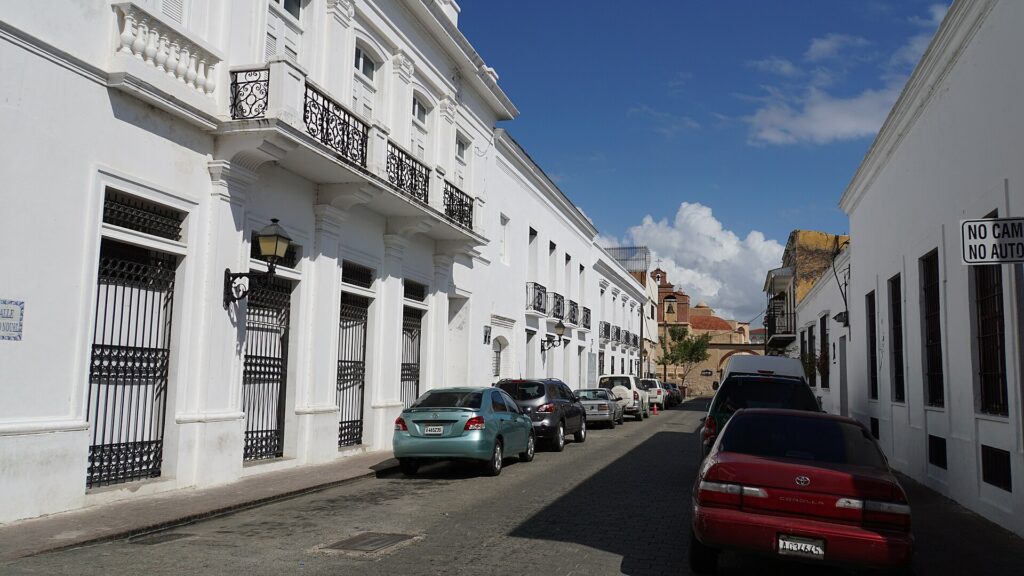 Street with white buildings and parked cars