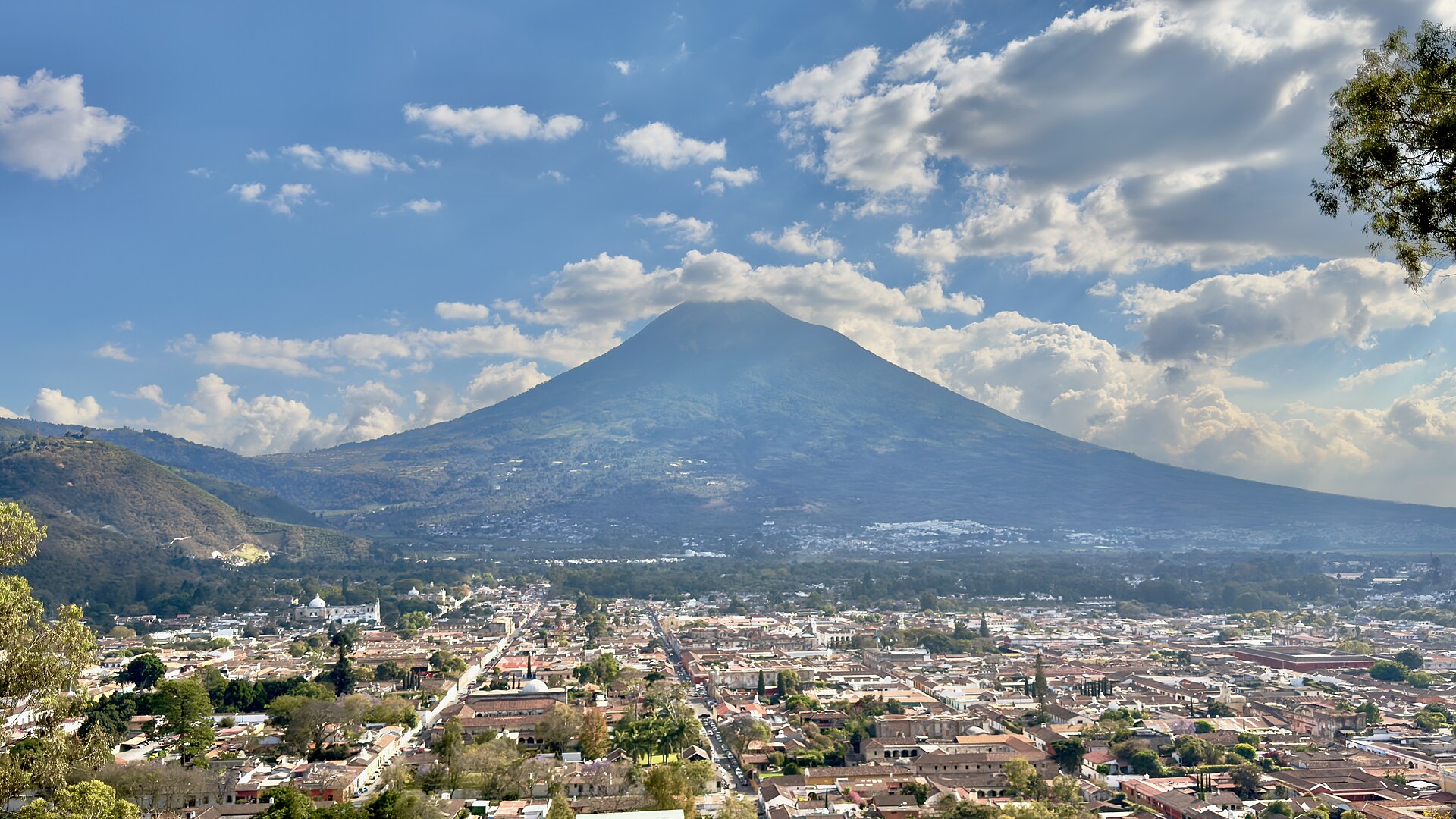 A colonial street in Antigua Guatemala with a volcano behind