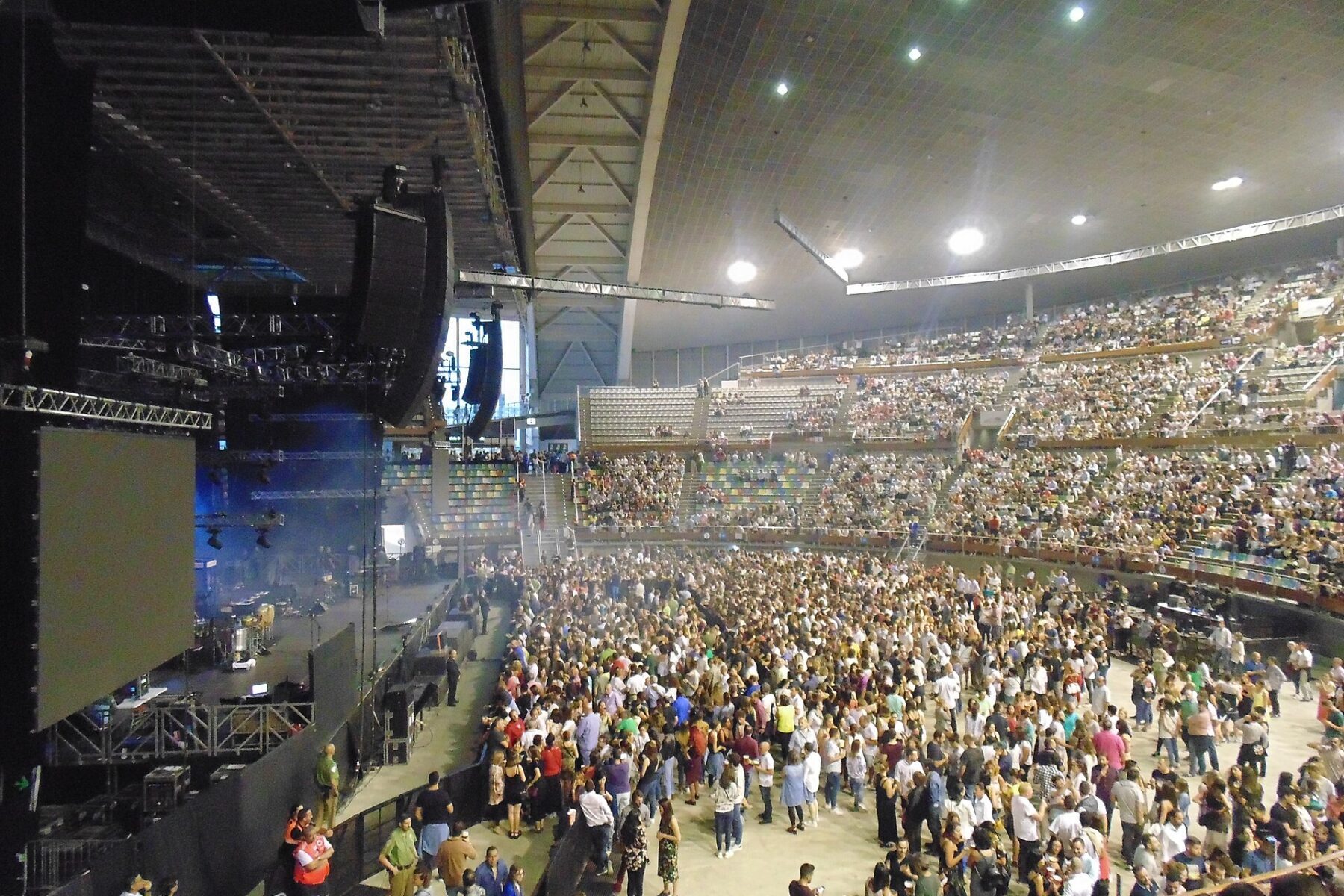 Large crowd in an arena with a stage setup