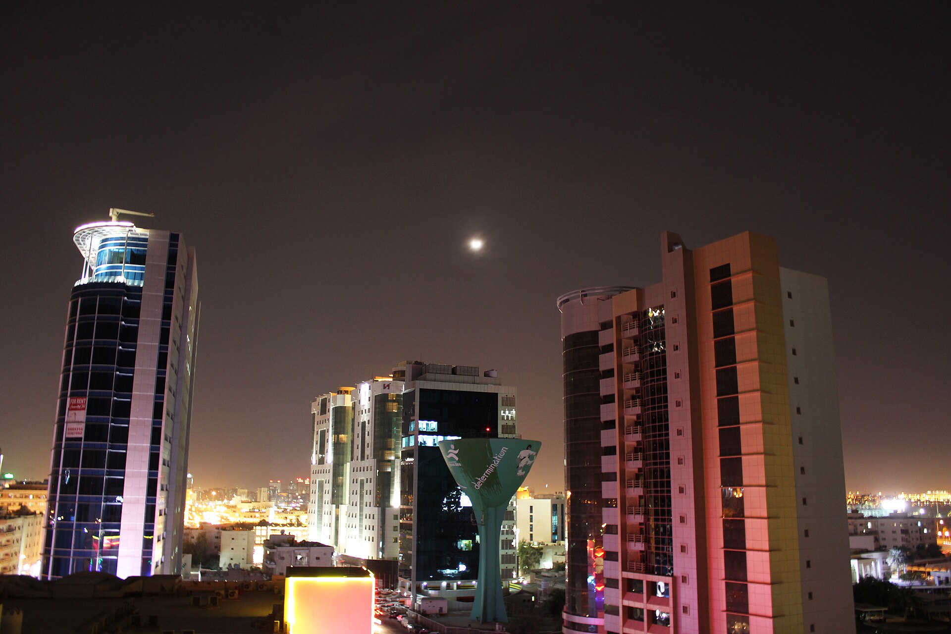 High-rise towers lit at night in Doha, Qatar
